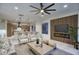 Open-concept living space featuring a fireplace, modern kitchen, and stylish seating area at 11566 E Christmas Cholla Dr, Scottsdale, AZ 85255