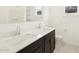 Modern bathroom with dual vanity sinks and dark cabinetry at 22464 W Tonopah Dr, Surprise, AZ 85387