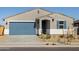 New construction home with blue garage door and desert landscaping at 22464 W Tonopah Dr, Surprise, AZ 85387