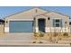 One-story house with a two-car garage and landscaped front yard at 22464 W Tonopah Dr, Surprise, AZ 85387