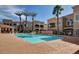 Community pool with palm trees and surrounding buildings at 8245 E Bell Rd # 240, Scottsdale, AZ 85260