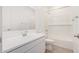 Pristine bathroom featuring a white vanity, tiled shower-tub, and modern fixtures for a clean, contemporary look at 12314 W Marguerite Ave, Avondale, AZ 85323