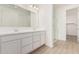 Modern bathroom with double sink vanity, sleek countertops, and walk-in glass shower at 12314 W Marguerite Ave, Avondale, AZ 85323