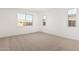 Carpeted bedroom bathed in natural light with three windows overlooking the exterior at 12314 W Marguerite Ave, Avondale, AZ 85323