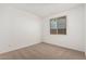 Neutral bedroom featuring carpet floors, white walls, and a sunlit window for a serene, comfortable space at 12314 W Marguerite Ave, Avondale, AZ 85323