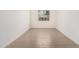 Sunlit empty room with wood-look flooring, a versatile blank canvas ready for your personal touch and design at 12314 W Marguerite Ave, Avondale, AZ 85323