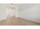 Bright empty room featuring stylish wood-look floors, neutral walls, offering versatile space for living and entertaining at 12314 W Marguerite Ave, Avondale, AZ 85323