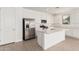 Well-lit kitchen with stainless steel appliances, white cabinets, and a center island with a sink at 12314 W Marguerite Ave, Avondale, AZ 85323