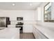 Modern kitchen with stainless steel appliances, white cabinets, and a gas range at 12314 W Marguerite Ave, Avondale, AZ 85323