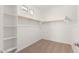 Spacious walk-in closet with carpet, window and built-in shelving for optimal storage and organization at 12314 W Marguerite Ave, Avondale, AZ 85323