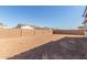 Large backyard enclosed with a tall block privacy wall, ideal for outdoor activities at 12330 W Marguerite Ave, Avondale, AZ 85323