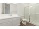 Bathroom featuring a single sink vanity, a toilet, and a glass-enclosed shower at 12330 W Marguerite Ave, Avondale, AZ 85323