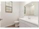 Powder room featuring wood-look tile flooring, a toilet, and a sink vanity with white cabinets at 12330 W Marguerite Ave, Avondale, AZ 85323