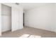 Bedroom with a closet, neutral carpeting, and a view into the hallway through an open door at 12330 W Marguerite Ave, Avondale, AZ 85323