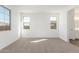 Carpeted bedroom with a neutral palette offers generous natural light from large windows at 12330 W Marguerite Ave, Avondale, AZ 85323