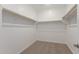 Walk-in closet featuring carpet flooring, white walls, and shelving at 12330 W Marguerite Ave, Avondale, AZ 85323