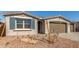 Charming single-story home with a neatly maintained desert landscape and three-car garage at 12330 W Marguerite Ave, Avondale, AZ 85323