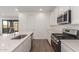 View of modern kitchen island, stainless appliances, white cabinets and stylish wood-look tile flooring at 12330 W Marguerite Ave, Avondale, AZ 85323