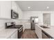 Open kitchen boasts stainless steel appliances, white cabinets, countertops, and island for modern living at 12330 W Marguerite Ave, Avondale, AZ 85323