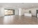 Spacious living room offering lots of natural light with an open floor plan and wood-look tile floors at 12330 W Marguerite Ave, Avondale, AZ 85323