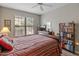 Comfortable bedroom with large window, dresser with a television, and a bookcase at 14950 W Mountain View Blvd # 1208, Surprise, AZ 85374