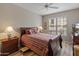 Inviting bedroom with a striped bed, matching nightstands, lamps, and a window view at 14950 W Mountain View Blvd # 1208, Surprise, AZ 85374