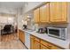 Bright kitchen featuring light wood cabinets, stainless steel appliances, and a view to office space at 14950 W Mountain View Blvd # 1208, Surprise, AZ 85374