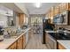 Bright kitchen with light wood cabinets, stainless steel appliances, and long countertops at 14950 W Mountain View Blvd # 1208, Surprise, AZ 85374