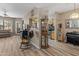 Open living room featuring light wood flooring, a rocking chair, and a view into the kitchen at 14950 W Mountain View Blvd # 1208, Surprise, AZ 85374