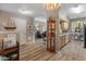 Open concept living room featuring light wood floors, display cabinet, and view to kitchen at 14950 W Mountain View Blvd # 1208, Surprise, AZ 85374