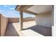 View of covered patio and expansive backyard with block fence at 25118 N 171St Ln, Surprise, AZ 85387