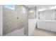 Contemporary bathroom featuring a dual sink vanity and a glass-enclosed walk-in shower at 25118 N 171St Ln, Surprise, AZ 85387