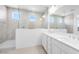 Contemporary bathroom featuring a dual sink vanity and a glass-enclosed walk-in shower at 25118 N 171St Ln, Surprise, AZ 85387