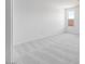 Bright, empty bedroom with a neutral carpet and lots of natural light from a window at 25118 N 171St Ln, Surprise, AZ 85387