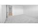 Bedroom with neutral carpet and a view into an adjoining hallway with a tiled floor at 25118 N 171St Ln, Surprise, AZ 85387