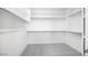 Walk-in closet featuring neutral carpet and shelving and rods for maximum storage at 25118 N 171St Ln, Surprise, AZ 85387