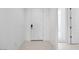View of a home's entryway with a white door and neutral tile flooring at 25118 N 171St Ln, Surprise, AZ 85387