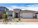 Inviting single-story home with a brick-paved driveway and low-maintenance desert landscaping at 25118 N 171St Ln, Surprise, AZ 85387