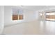 Bright open living room featuring tile flooring, ample natural light, and access to the backyard at 25118 N 171St Ln, Surprise, AZ 85387