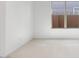 This room has neutral tile floors, white walls, and plenty of natural light from the window at 25118 N 171St Ln, Surprise, AZ 85387