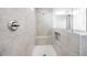 Luxurious walk-in shower featuring neutral tile, a shower seat, and recessed shelving at 25118 N 171St Ln, Surprise, AZ 85387