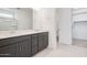 Bathroom features double sinks with gray cabinets, white countertops, and a separate toilet room at 25206 N 172Nd Ln, Surprise, AZ 85387