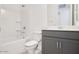Cozy bathroom with tub and vanity with gray cabinets and solid surface countertop at 25206 N 172Nd Ln, Surprise, AZ 85387