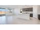 Open-concept kitchen features a large island, stainless steel appliances, and sliding glass doors to the backyard at 25206 N 172Nd Ln, Surprise, AZ 85387