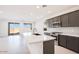 Modern kitchen featuring an island, stainless steel appliances, and stylish gray cabinetry at 25206 N 172Nd Ln, Surprise, AZ 85387