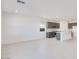 Spacious living area with tile floors, white walls, recessed lighting and an adjacent kitchen area at 25206 N 172Nd Ln, Surprise, AZ 85387