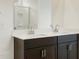 Bathroom vanity with double sinks, dark wood cabinets, and a large mirror at 3337 E Alexander Dr, San Tan Valley, AZ 85143