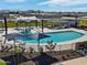 Resort-style community pool featuring lounge chairs, umbrellas, and splash pad under an open sky at 3337 E Alexander Dr, San Tan Valley, AZ 85143