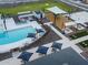 Community pool aerial view with lounge chairs, tables, playground, and picnic area at 3337 E Alexander Dr, San Tan Valley, AZ 85143