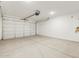Spacious garage with large door, concrete floor and mechanical components at 3337 E Alexander Dr, San Tan Valley, AZ 85143